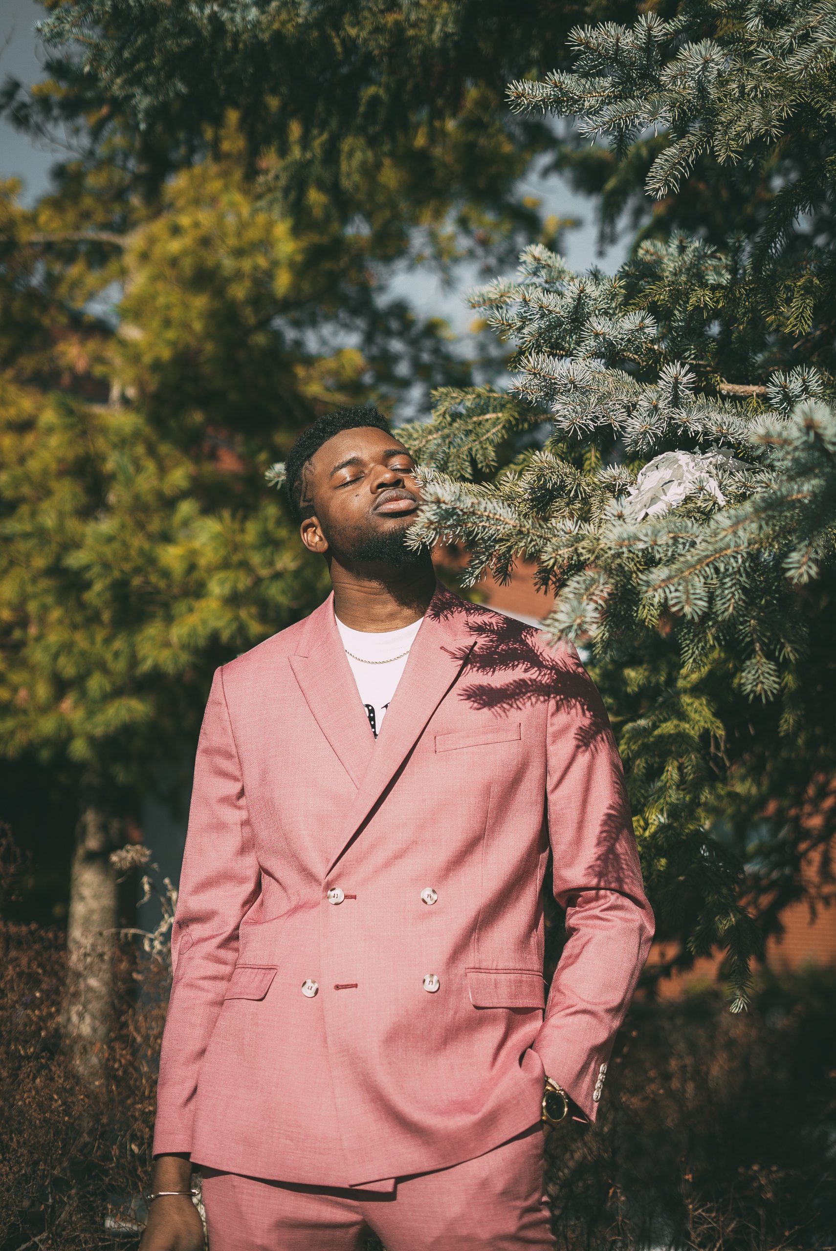 man-in-pink-suit-standing-near-green-tree-3856979-scaled